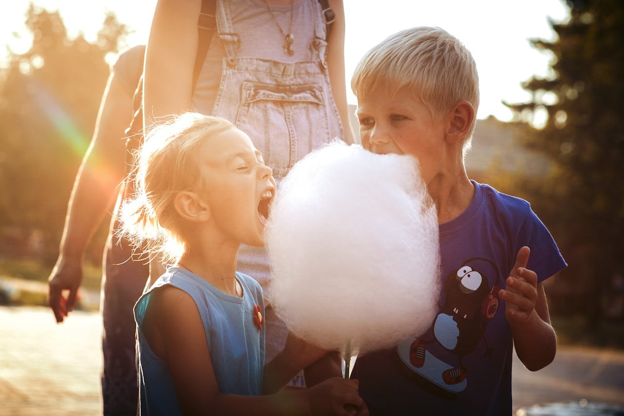 Children enjoying a big candy floss